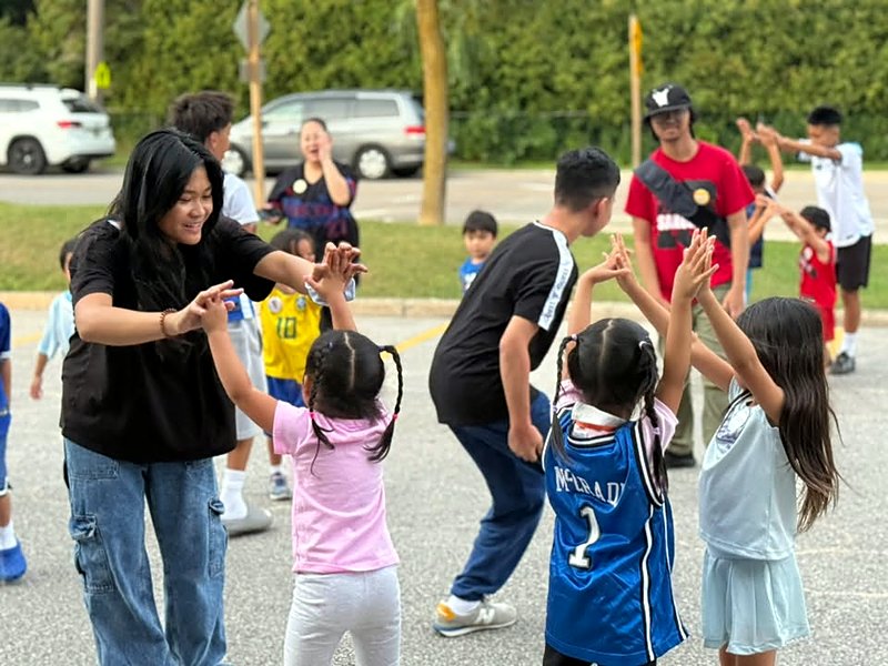 Kids playing a game outdoors with youth leaders